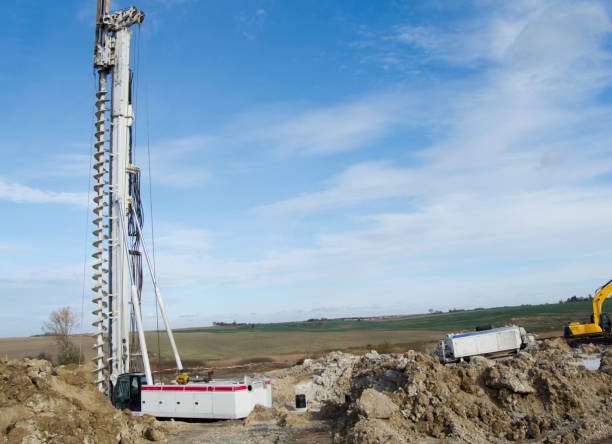 istock Building activity on contruction site.Drilling machine.Wind turbine construction.
Excavator and other construction equipment. 2182657006