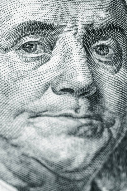 istock Macro image of Benjamin Franklin on the one hundred US Dollar bill. Selective focus on eyes. Vertical image. 2182658887