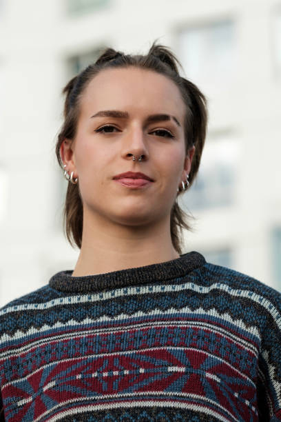 istock Young woman with piercings posing in urban setting 2182664372