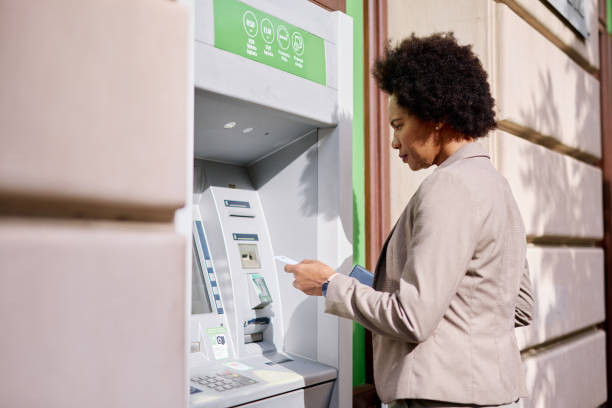 istock Confident Woman Using ATM Machine on a Sunny Day 2182666160