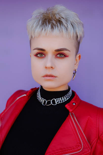 istock Confident woman with red makeup looking at camera on purple backdrop 2182666261