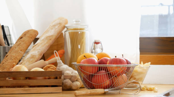 istock Kitchen background home interior bright simple decorate with bread garlic apple oil Preparing food meal. Warm home interior defocused mockup food shelf living space. Home showcase kitchen restaurant 2182666716