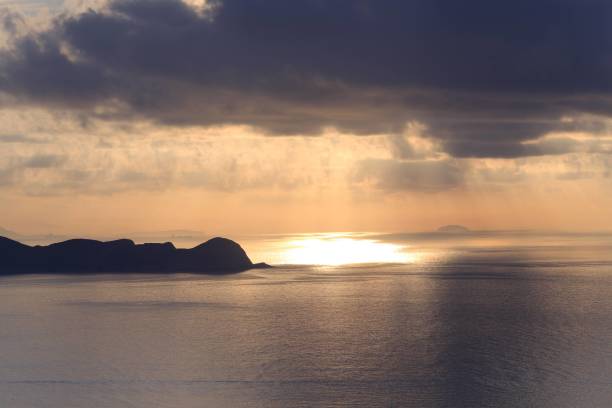 istock Serene Sunset Over Calm Ocean with Cloudy Sky 2182667238