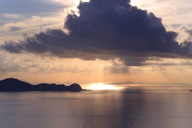 istock Serene Sunset Over Calm Ocean with Cloudy Sky 2182667264