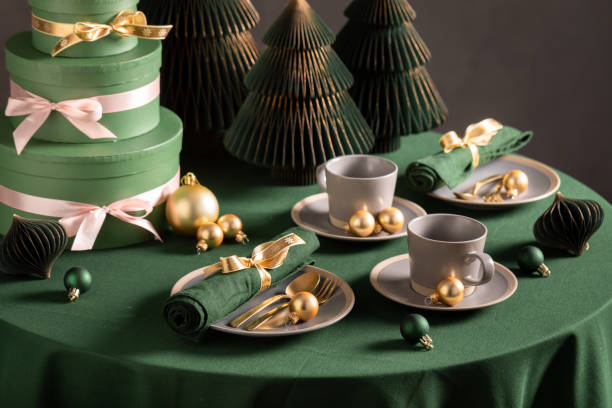 istock Modern green Christmas tableware for two with baubles and decorations. 2182670425