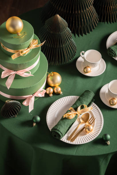 istock Lovely green table set for Christmas with tableware and presents. 2182670692