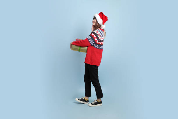 istock Woman wearing Santa hat 2182672167