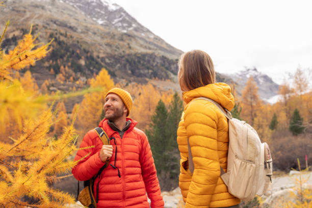 istock Couple Enjoying Scenic Fall Hike in Mountain Landscape 2182673120