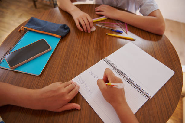 istock Students studying together with notebooks and stationery on a table 2182673782
