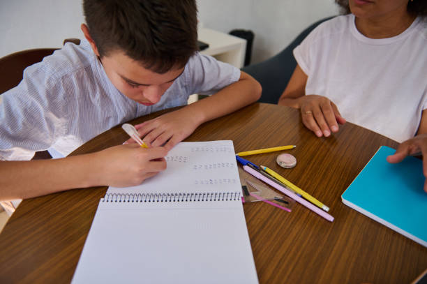 istock Young boy receiving guidance for his homework at the table 2182673815