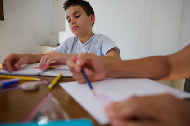 istock Young boy focused on school homework at home 2182673884