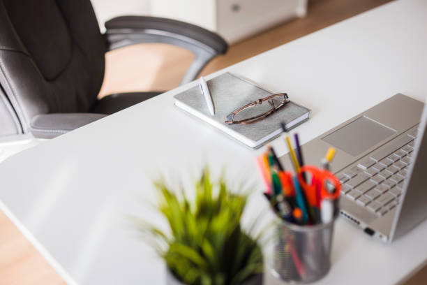 Work desk having office items on it, ne people at the office