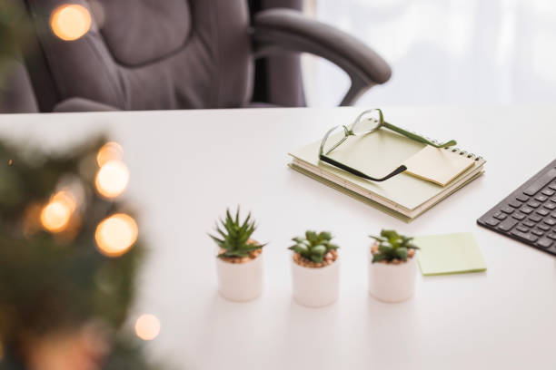 Christmas holidays at the office, desk decorated with mini Christmas tree