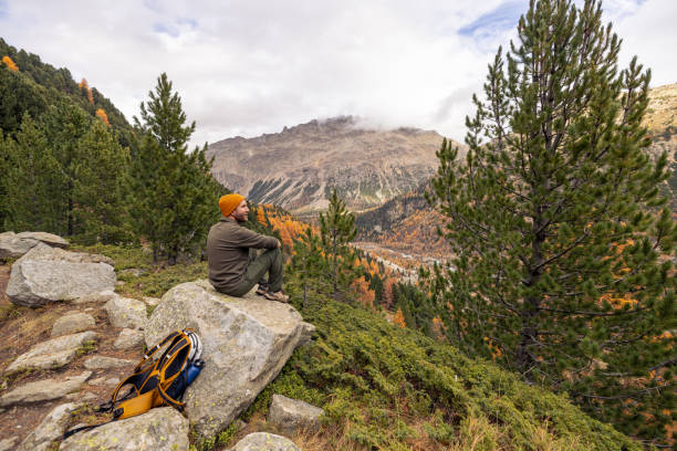 istock Man Resting on Rock with Scenic Mountain View in Autumn 2182674872