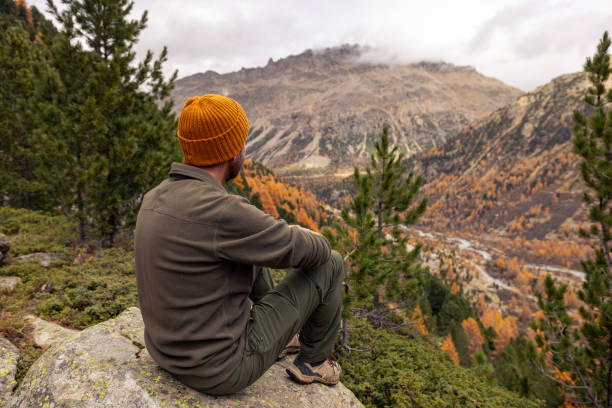 istock Man Resting on Rock with Scenic Mountain View in Autumn 2182674881