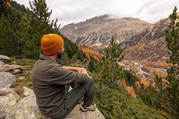 istock Man Resting on Rock with Scenic Mountain View in Autumn 2182674898