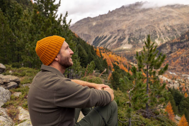 istock Man Resting on Rock with Scenic Mountain View in Autumn 2182674918