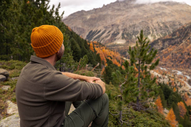 istock Man Resting on Rock with Scenic Mountain View in Autumn 2182674928