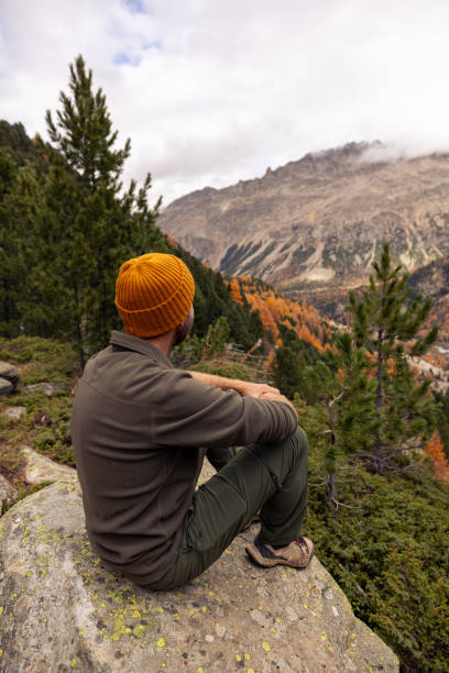 istock Man Resting on Rock with Scenic Mountain View in Autumn 2182674933