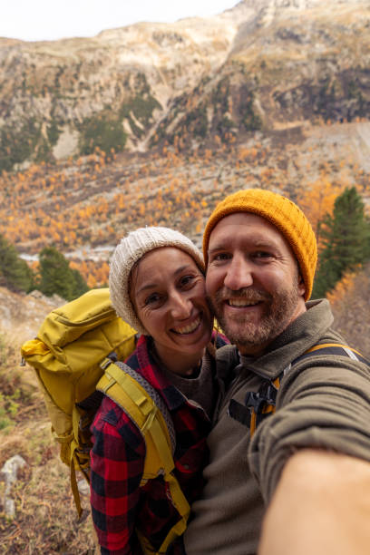 istock Smiling Couple Takes Selfie on Mountain Hike 2182675049