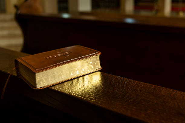 istock Leather-Bound Bible on Wooden Church Pew 2182677931