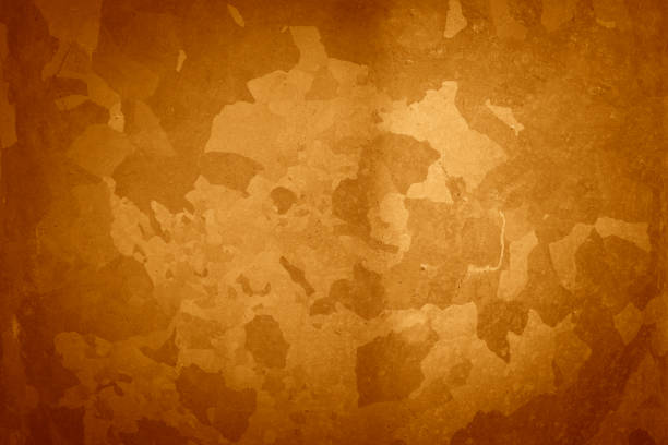 Abstract bright orange texture with spots and color changes from dark to light
