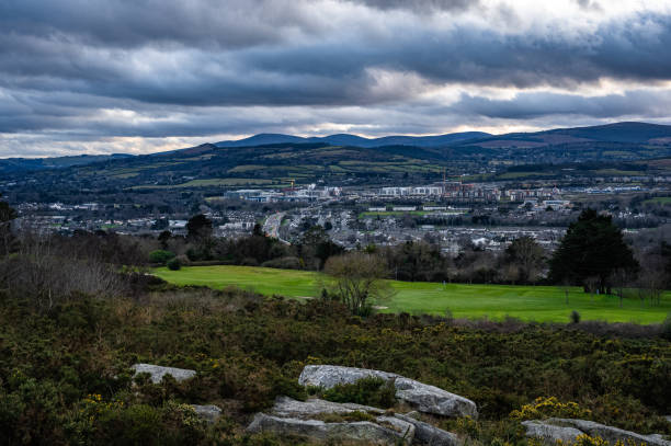 Knocknarea Mountain peak, or Cnoc na Riabh in Irish, also called the Hill of Kings or Hill of Maeve, rises above the Coolera Peninsula near Strandhill in Ireland, a tranquil winter landscape over the green.