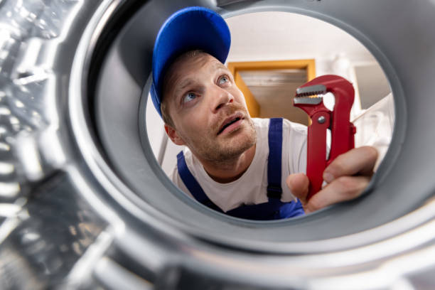 istock washing machine repair service. repairman looking inside drum 2182686768