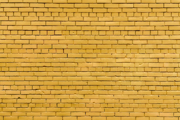 istock Home and office design backdrop wallpaper. Background of yellow brick wall texture. 2182687695