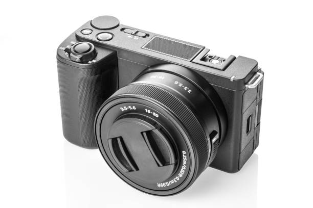 Modern digital small mirrorless photo and video camera isolated on white background