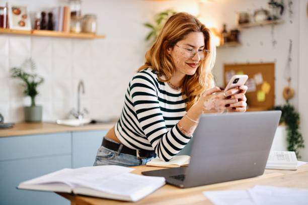 istock Side view of a student text messaging with someone 2182688322