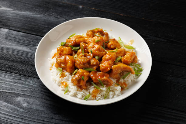 istock Chinese orange chicken with rice and green onion garnish 2182692206