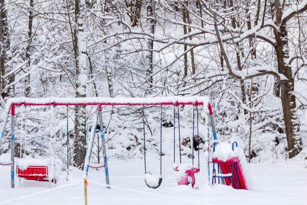 istock Snow-Covered Playground in a Quiet Winter Forest Setting 2182694587