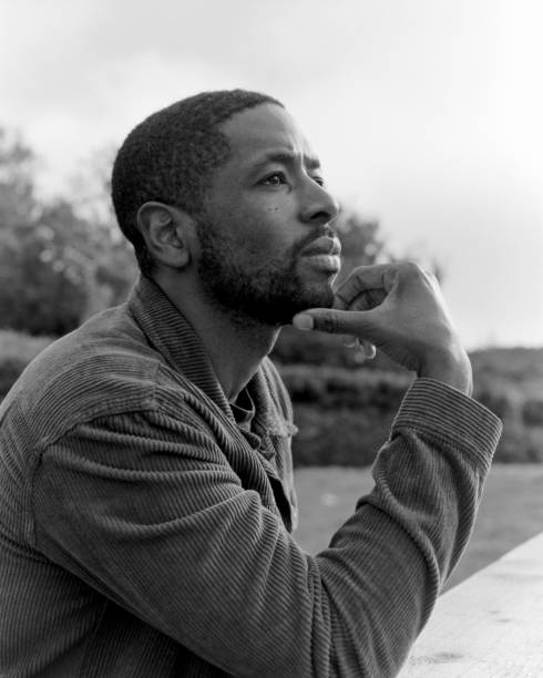 istock Pensive man pondering outdoors in black and white 2182696119