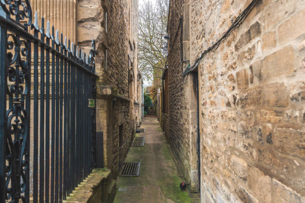 Narrow corridor between two houses made of clicker bricks