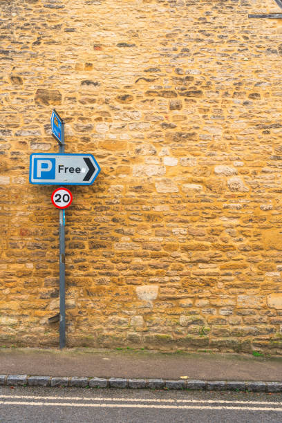 Parking sign by a brick wall