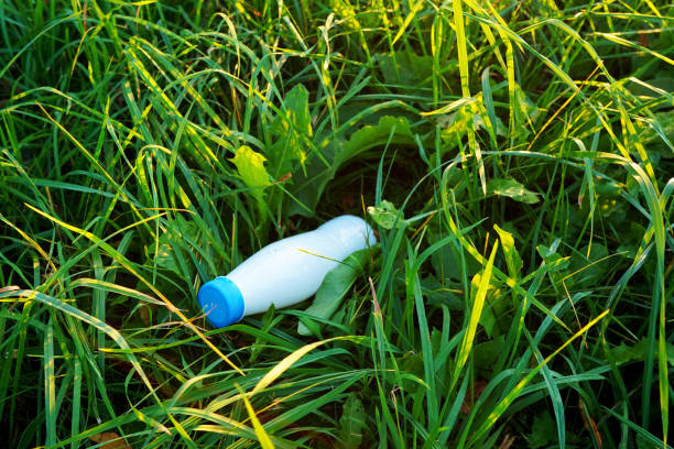 istock Plastic bottle in grass. Discarded plastic bottle. Throwing garbage in nature, pollution 2182704382
