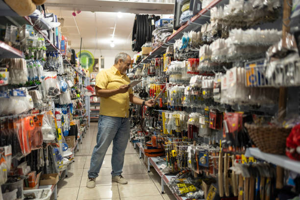istock Man checking merchandise and stock with tablet in household goods store 2182706493
