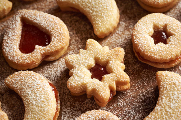 Linzer Christmas cookies filled with jam and dusted with sugar, closeup