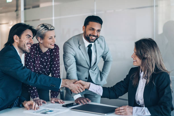 istock Businesswoman shaking hands with a coworker 2182716657