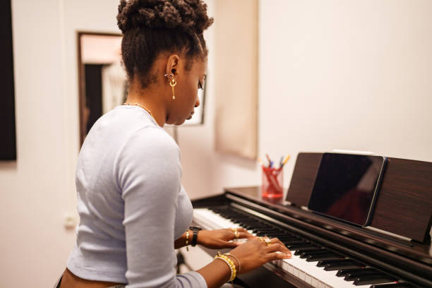 istock Woman is using digital tablet and playing piano. 2182723804