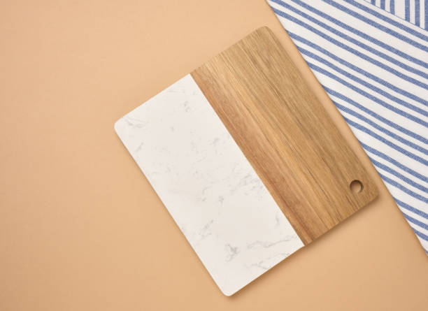 istock Empty wooden kitchen cutting board on a brown background, top view 2182724169