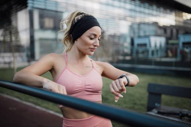 istock Woman Tracking Pulse and Heart Rate on a Smartwatch While Exercising 2182729784