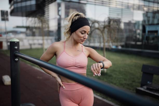 istock Woman Tracking Pulse and Heart Rate on a Smartwatch While Exercising 2182730279
