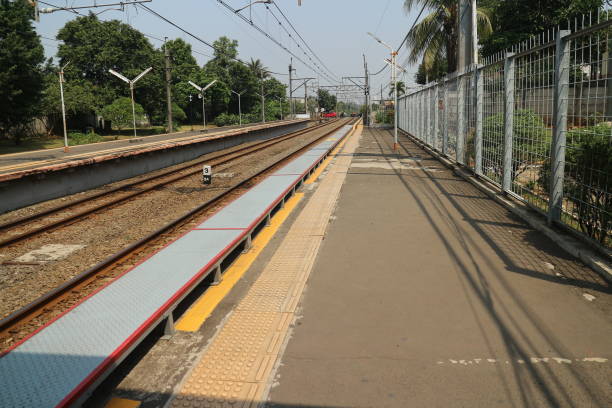 istock Empty Train Station Platform with Tracks and Overhead Wires 2182730746