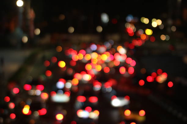 Blurred image of city traffic lights at night, creating a bokeh effect.
