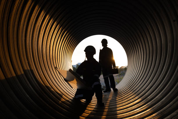 istock young two male construction specialists were collaborating in a large sewer to evaluate the quality of the piping. Light at the end of the destination. 2182731656