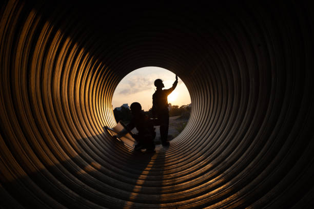 istock young two male construction specialists were collaborating in a large sewer to evaluate the quality of the piping. Light at the end of the destination. 2182731684