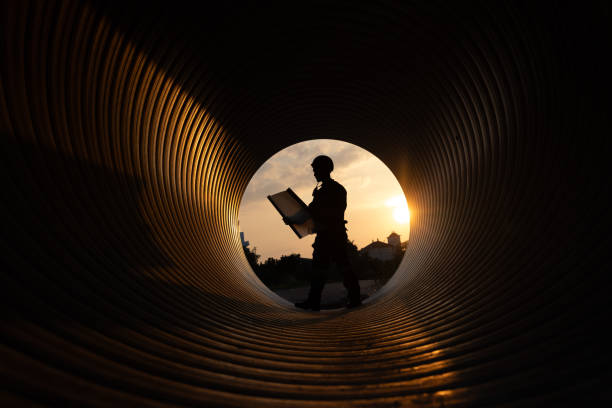 istock young two male construction specialists were collaborating in a large sewer to evaluate the quality of the piping. Light at the end of the destination. 2182731737