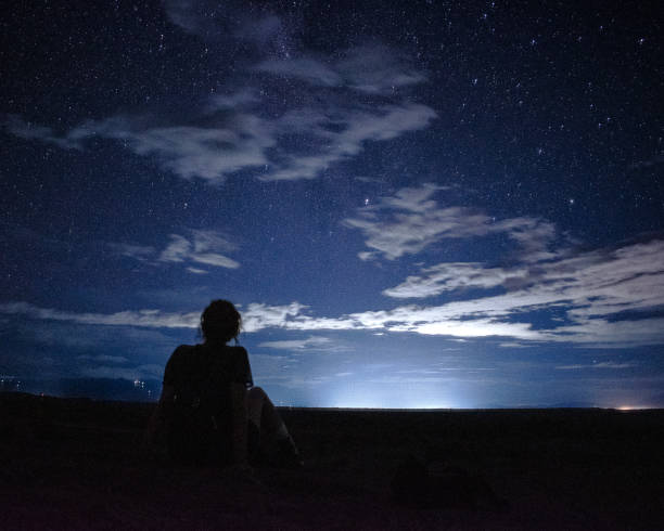 istock Stargazing Woman Under a Starry Night Sky 2182736092